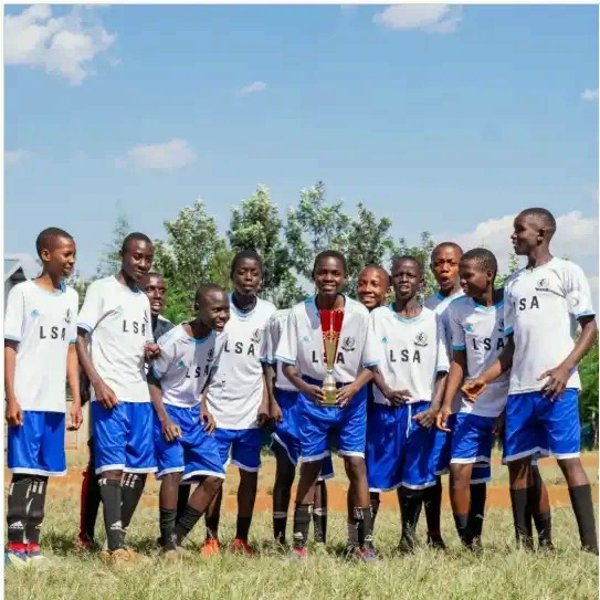 An academy squad with a cup after a fixture